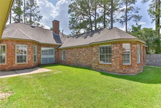 a view of a house with a yard and sitting area