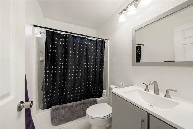 a backyard of a house with a fountain table and chairs