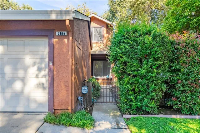 a front view of a house with trees
