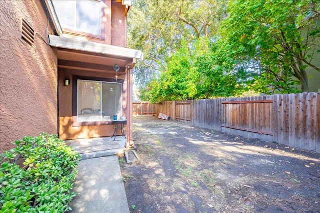 a view of a chair and table in the backyard