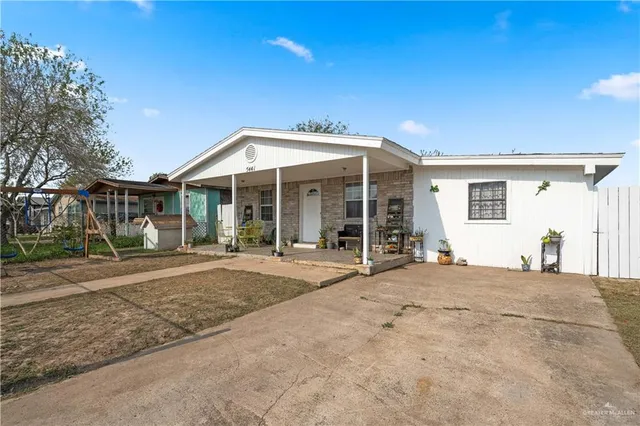 a blue house with yard in front of it