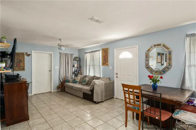 a living room with furniture a mirror and a table