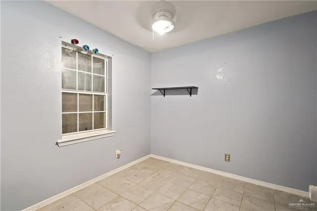 an empty room with windows and closet