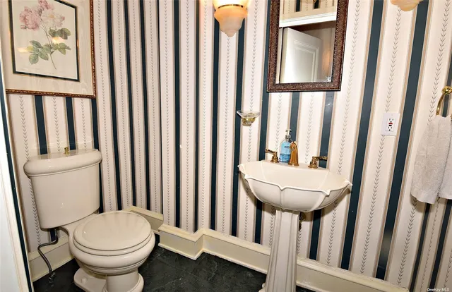 a bathroom with a toilet and a sink