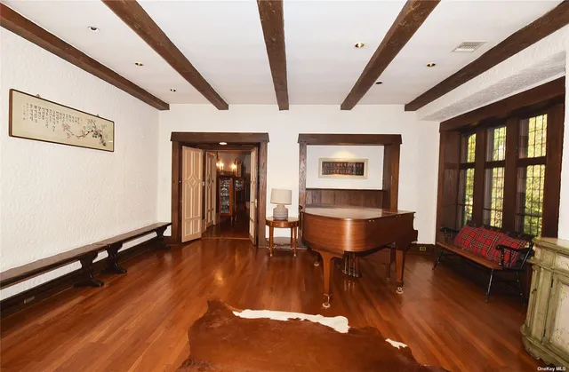 a living room with furniture rug and wooden floor