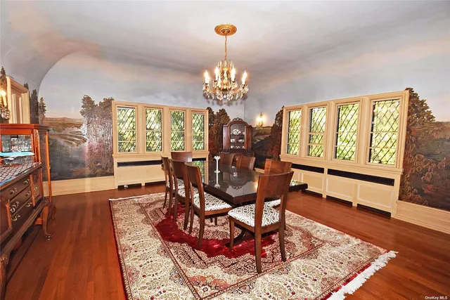 a view of a dining room with furniture a chandelier and wooden floor
