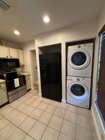 a view of a kitchen with a washer and dryer