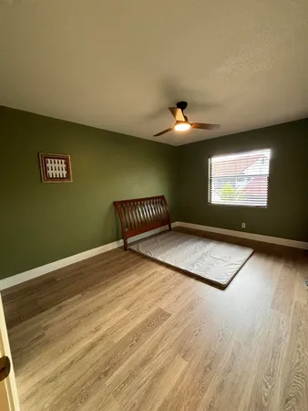a view of a room with wooden floor and window