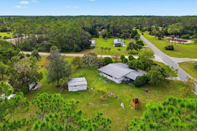 an aerial view of a house with yard swimming pool and outdoor seating