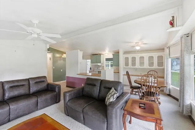 a view of living room with furniture and large windows