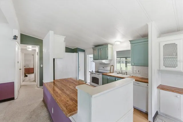 a view of kitchen with kitchen island a sink and a stove