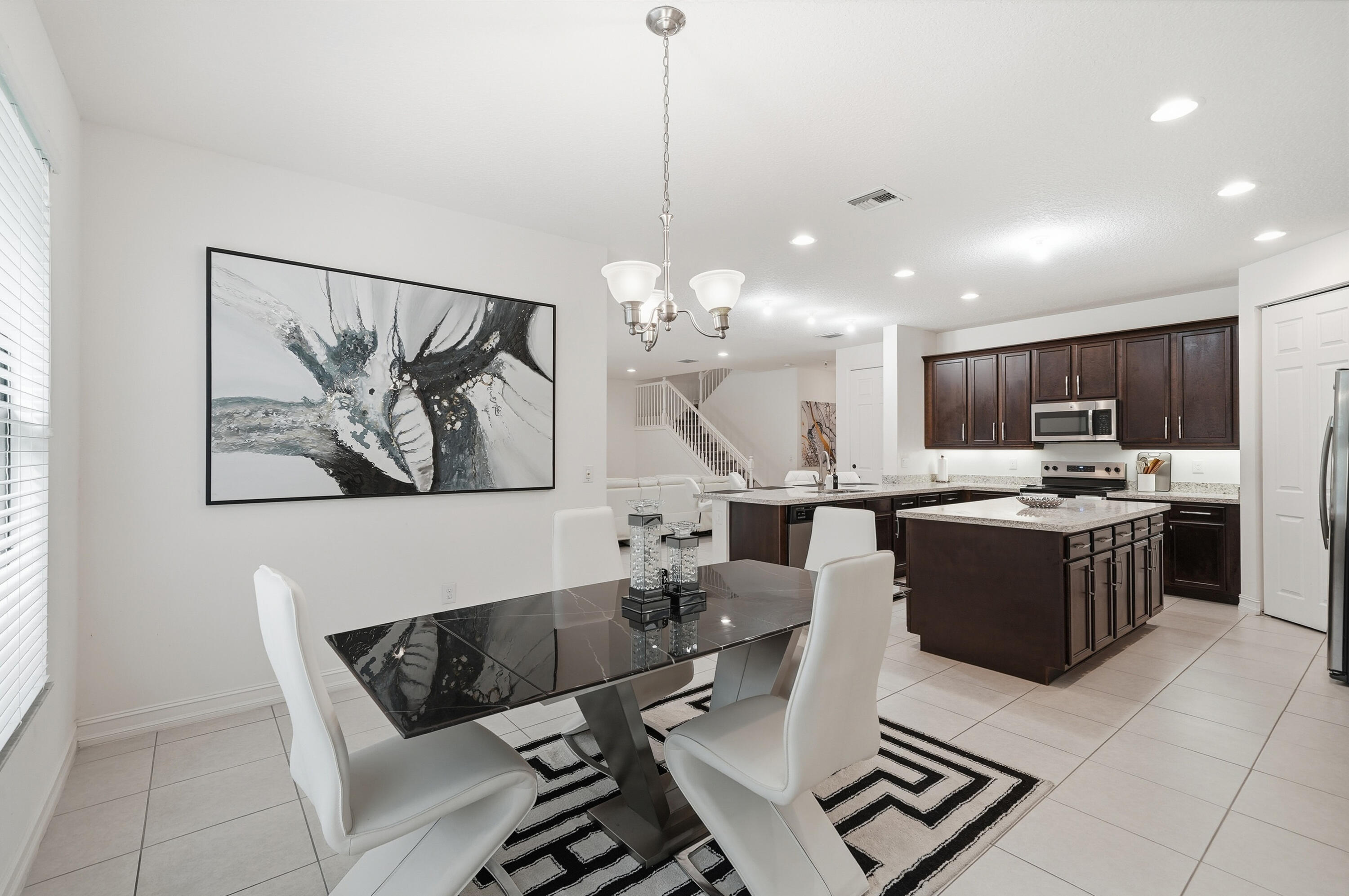 14085 Paverstone Terrace Delray Beach, FL 33446 - Photo 16 of 46 a living room with couches and kitchen view with wooden floor