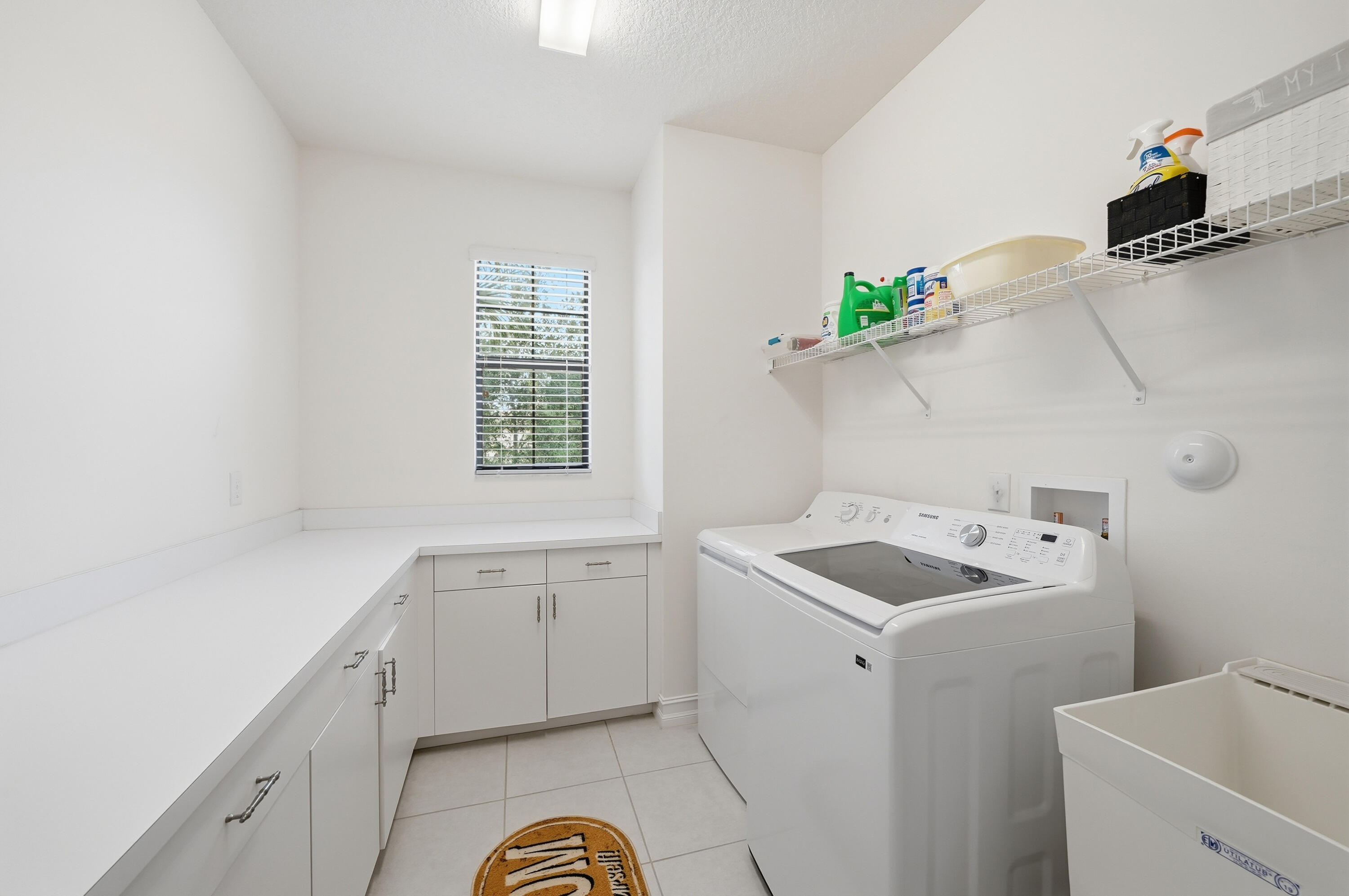 14085 Paverstone Terrace Delray Beach, FL 33446 - Photo 19 of 46 a utility room with a sink dryer and washer