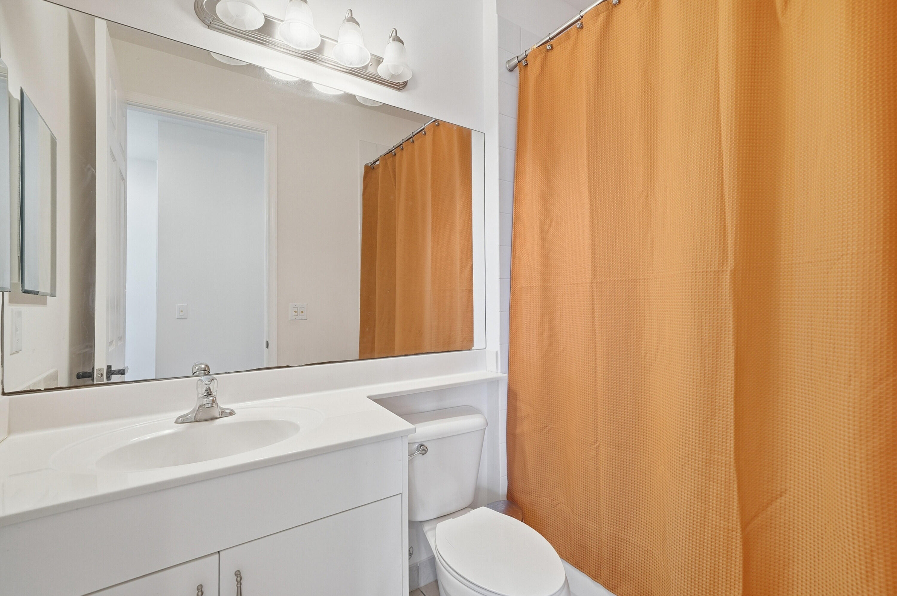14085 Paverstone Terrace Delray Beach, FL 33446 - Photo 24 of 46 a bathroom with a sink a toilet and a mirror