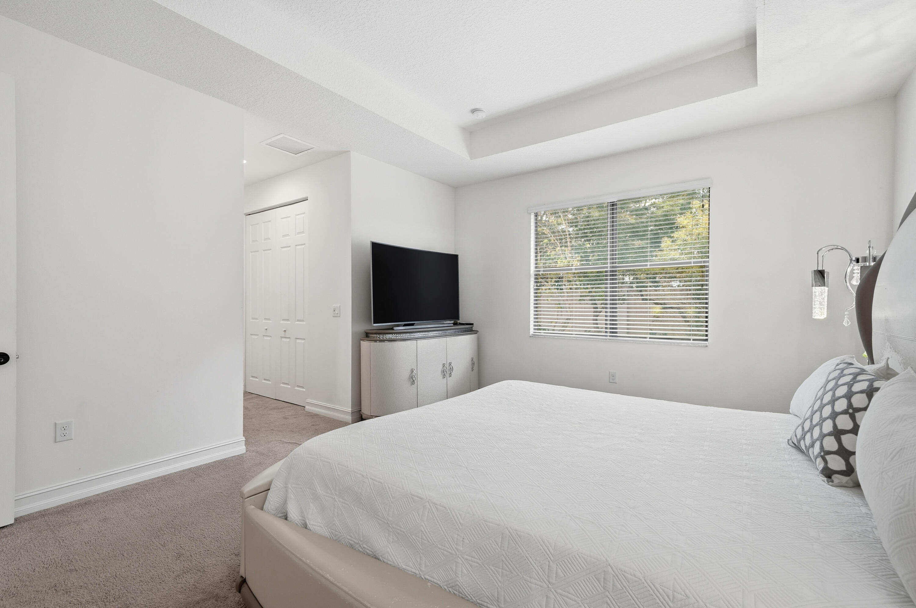 14085 Paverstone Terrace Delray Beach, FL 33446 - Photo 26 of 46 a bedroom with a bed and a flat screen tv