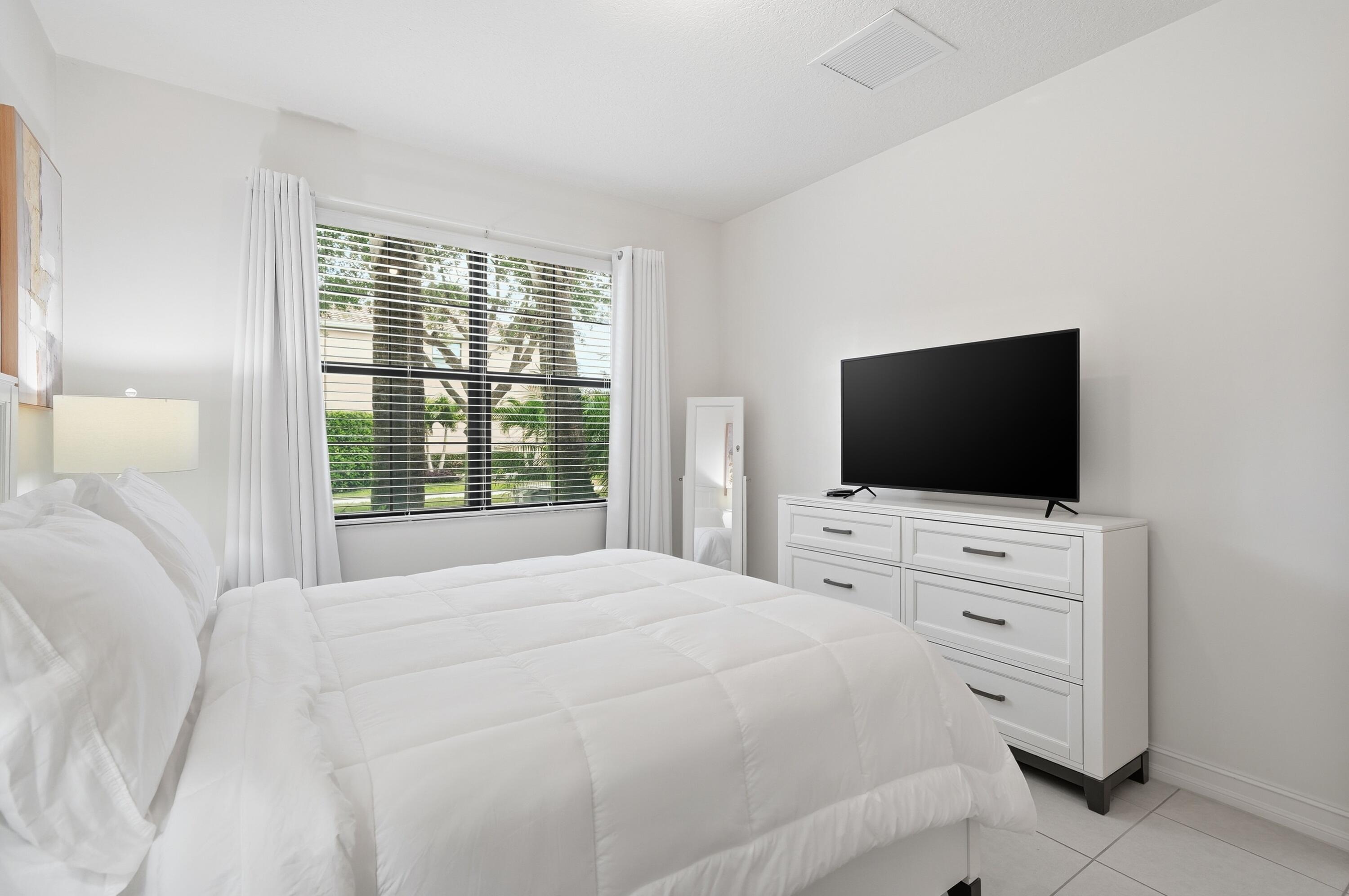 14085 Paverstone Terrace Delray Beach, FL 33446 - Photo 36 of 46 a bedroom with a flat screen tv and a bed