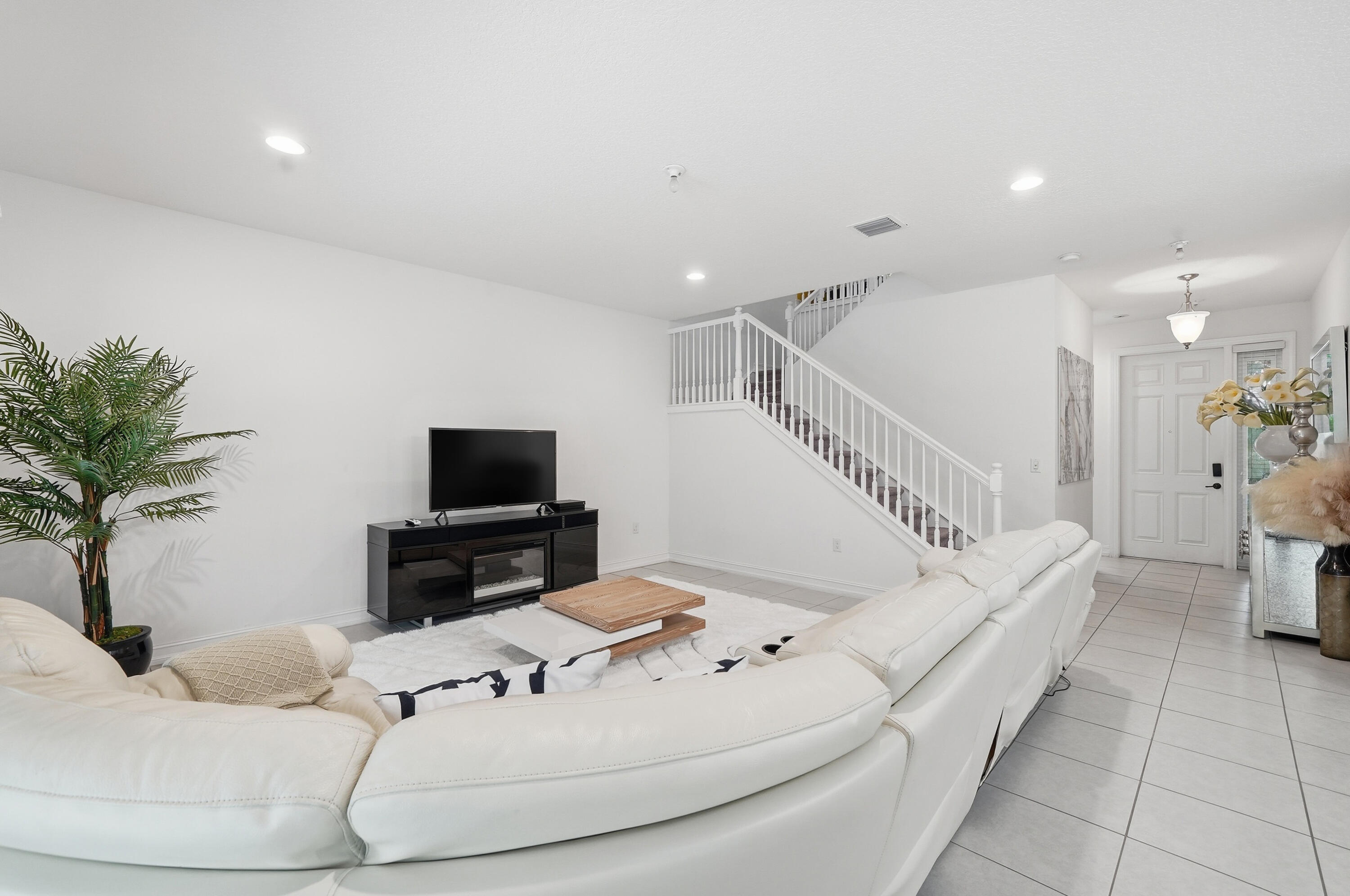 14085 Paverstone Terrace Delray Beach, FL 33446 - Photo 5 of 46 a living room with furniture and a flat screen tv