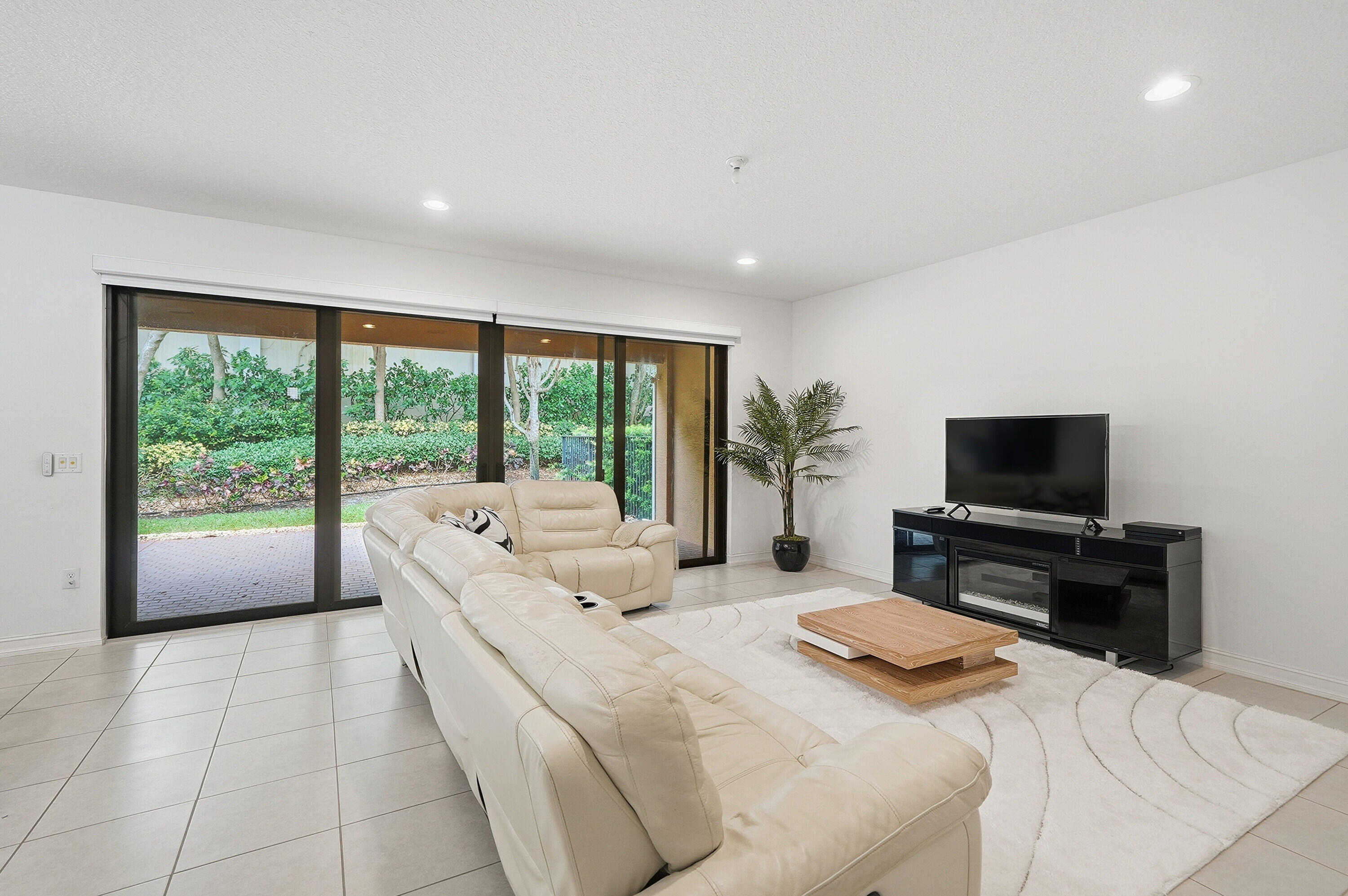 14085 Paverstone Terrace Delray Beach, FL 33446 - Photo 6 of 46 a bedroom with a large bed and a flat screen tv