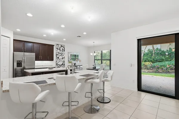 a kitchen with a sink a refrigerator and a stove top oven