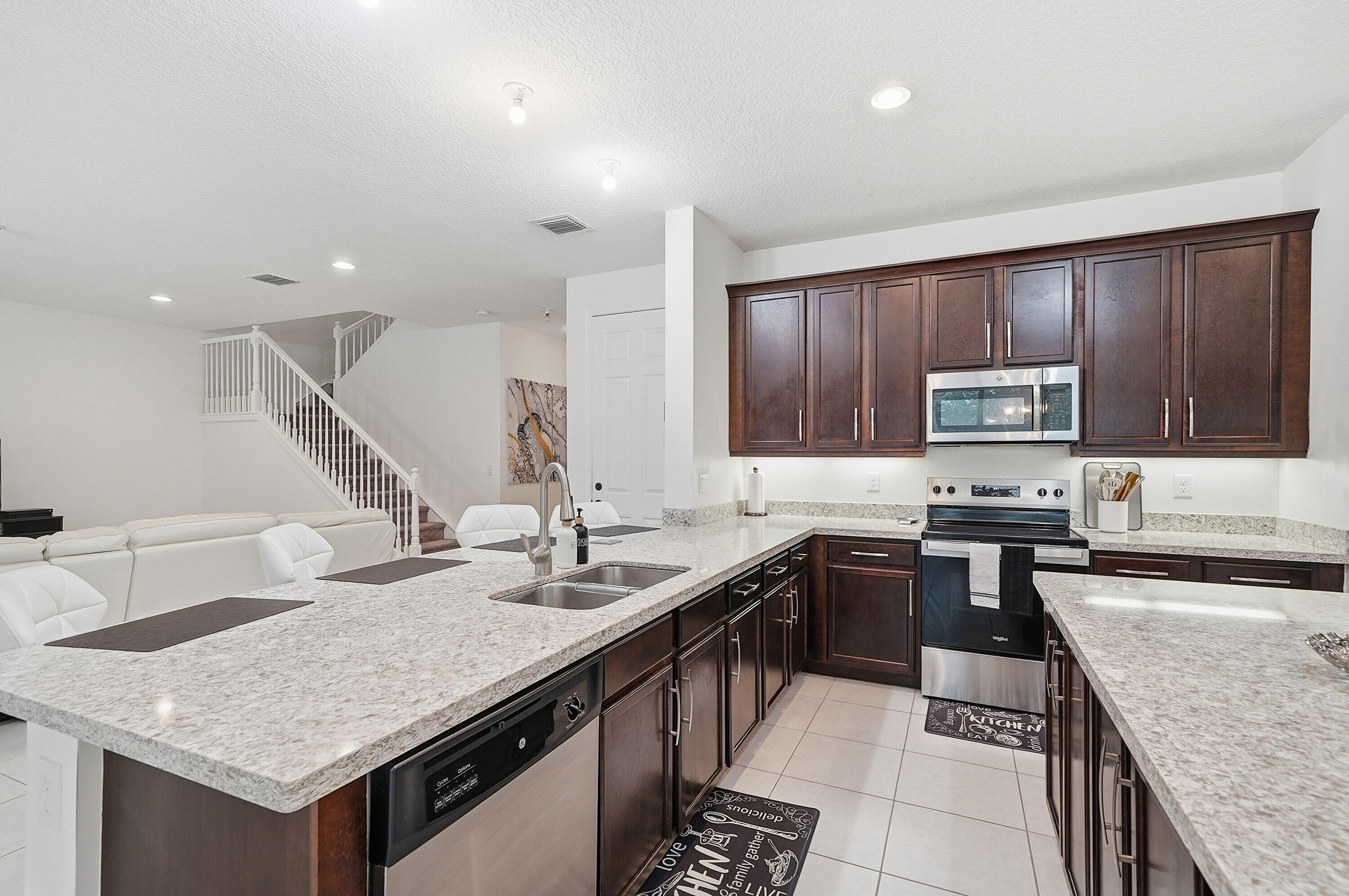 14085 Paverstone Terrace Delray Beach, FL 33446 - Photo 10 of 46 a kitchen with stainless steel appliances granite countertop a sink stove and cabinets