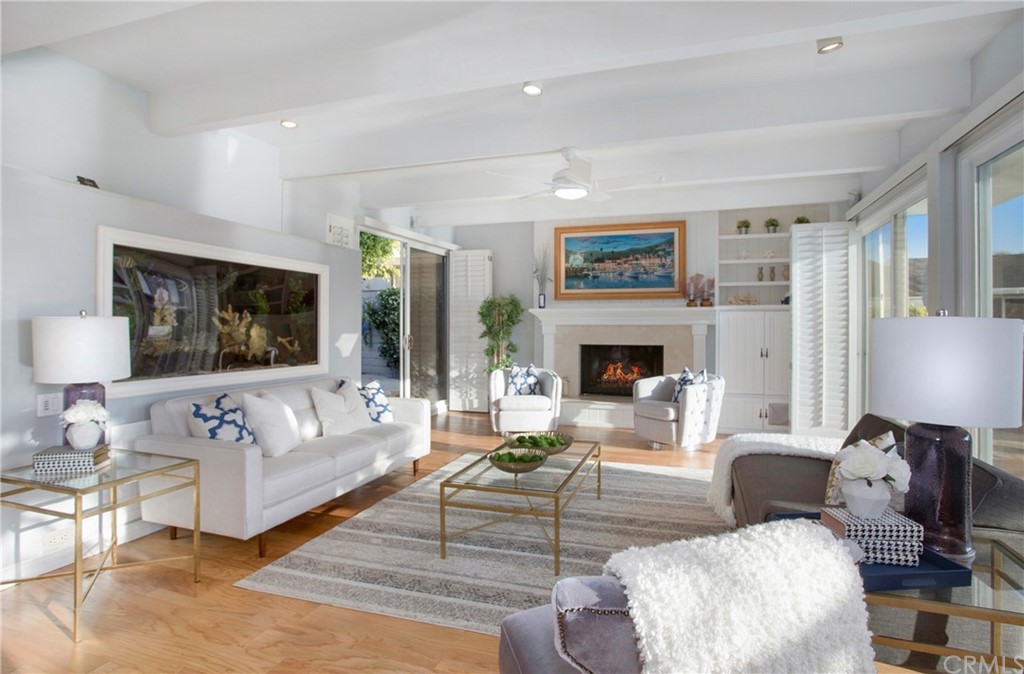 16631 Edgewater Lane Huntington Beach, CA 92649 - Photo 14 of 55 a living room with furniture large window and a fireplace