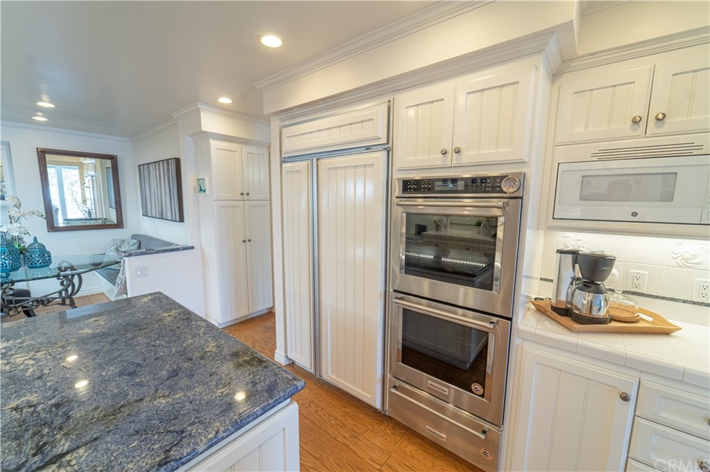 16631 Edgewater Lane Huntington Beach, CA 92649 - Photo 22 of 55 a kitchen with granite countertop a refrigerator stove and sink