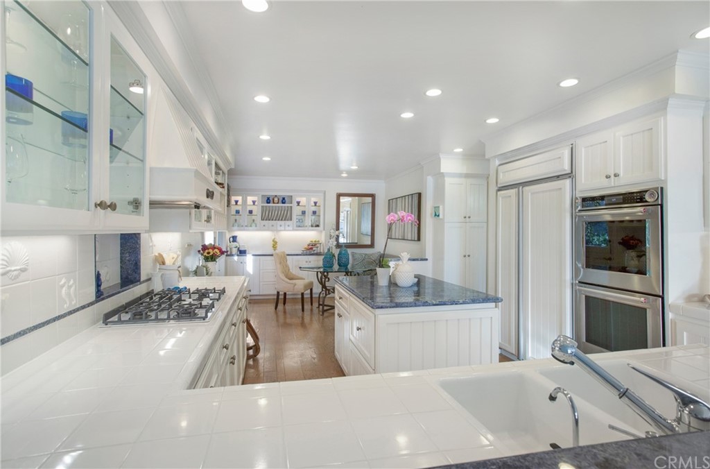 16631 Edgewater Lane Huntington Beach, CA 92649 - Photo 23 of 55 a living room with stainless steel appliances furniture a rug and a kitchen view