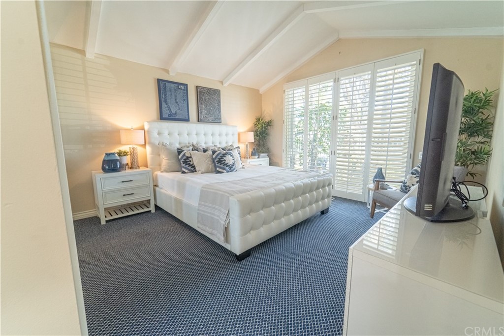 16631 Edgewater Lane Huntington Beach, CA 92649 - Photo 26 of 55 a bedroom with a bed and a large window