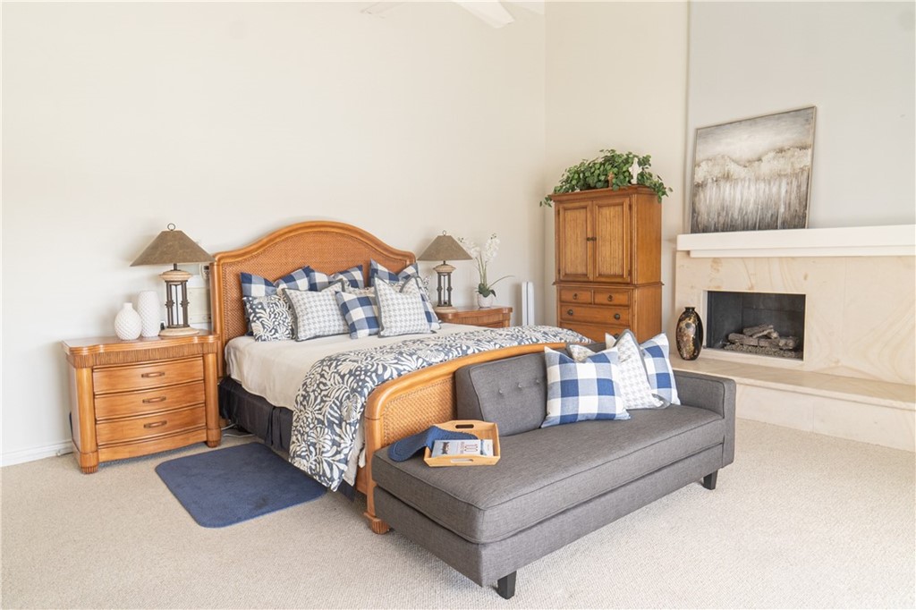 16631 Edgewater Lane Huntington Beach, CA 92649 - Photo 31 of 55 a bedroom with furniture and a fireplace