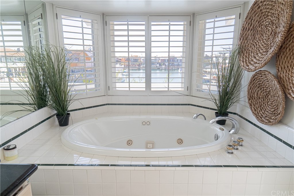16631 Edgewater Lane Huntington Beach, CA 92649 - Photo 38 of 55 a bathroom with bathtub and window