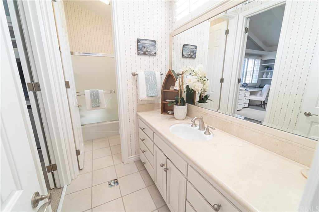 16631 Edgewater Lane Huntington Beach, CA 92649 - Photo 43 of 55 a spacious bathroom with a double vanity sink and a mirror