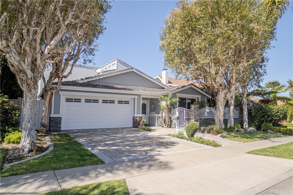 16631 Edgewater Lane Huntington Beach, CA 92649 - Photo 7 of 55 a front view of a house with a yard and garage