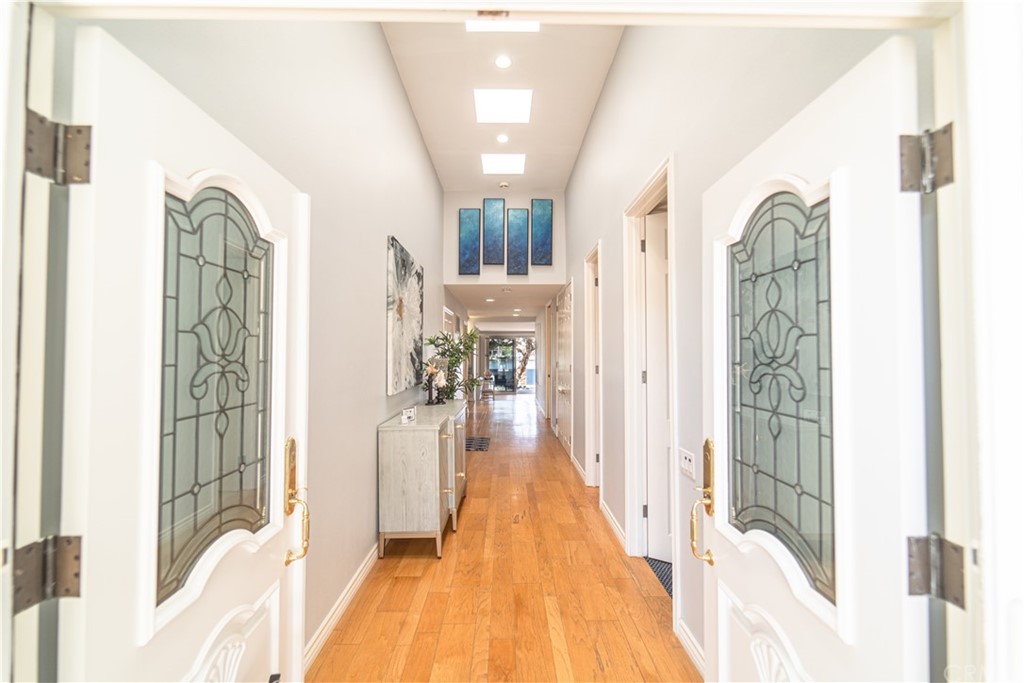 16631 Edgewater Lane Huntington Beach, CA 92649 - Photo 8 of 55 a view of a hallway with wooden floor and stairs