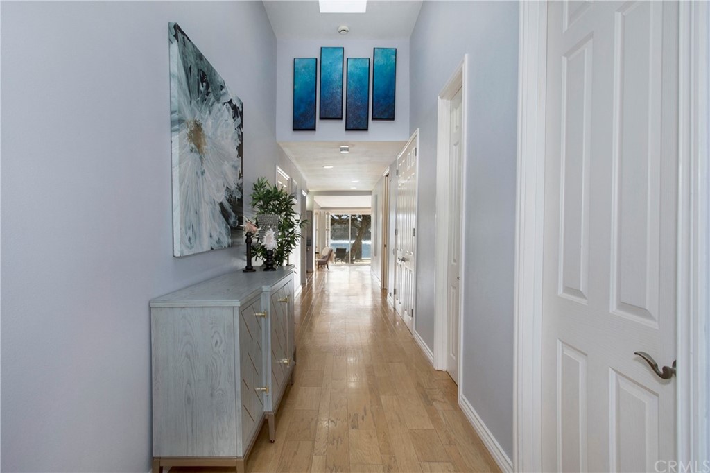 16631 Edgewater Lane Huntington Beach, CA 92649 - Photo 9 of 55 a view of a hallway with wooden floor and staircase