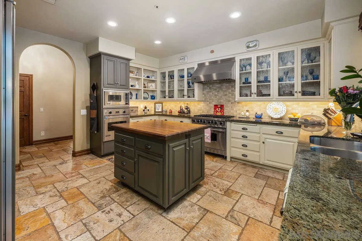 648 Rolling Hills Road Vista, CA 92081 - Photo 4 of 5 a kitchen with stainless steel appliances granite countertop a stove and a sink