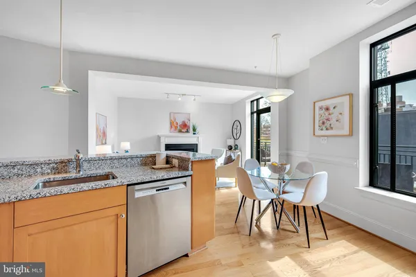 a kitchen with granite countertop a sink stove and cabinets