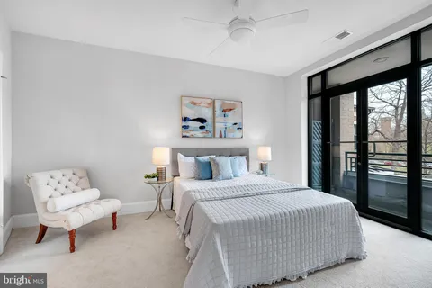 a bedroom with a large bed and a chandelier