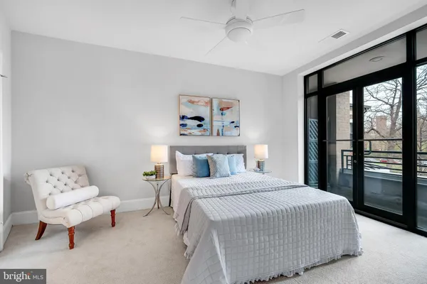 a bedroom with a large bed and a chandelier