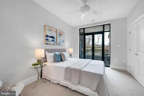 a bedroom with a large bed and a large window