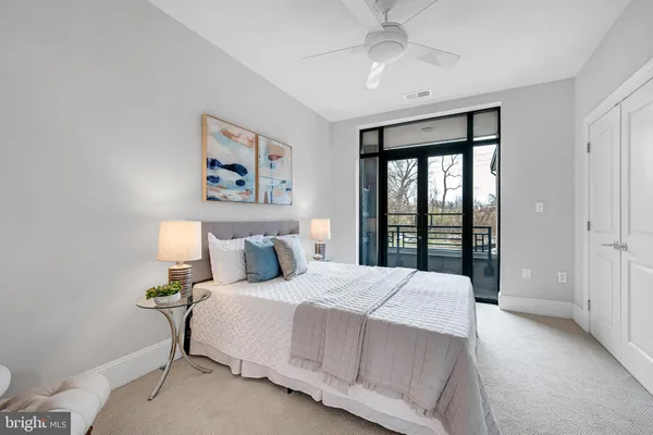 a bedroom with a large bed and a large window