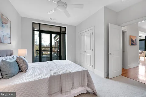 a bedroom with a bed and a lamp