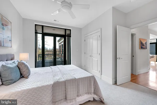 a bedroom with a bed and a lamp