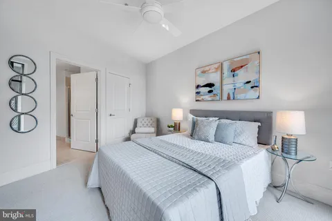 a bedroom with a bed and a painting on the wall