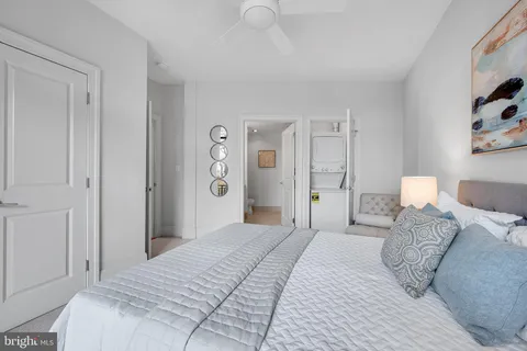 hallway with wooden door washer and dryer
