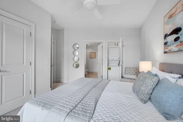 hallway with wooden door washer and dryer