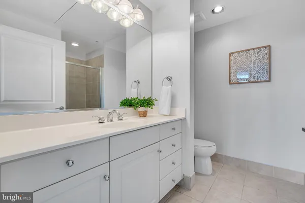 a en suite bathroom with a double vanity sink a mirror and a shower