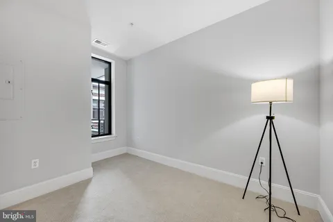 an empty room with windows and closet