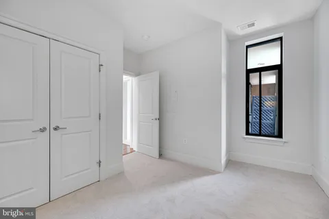 a roof deck with a potted plant and outdoor seating