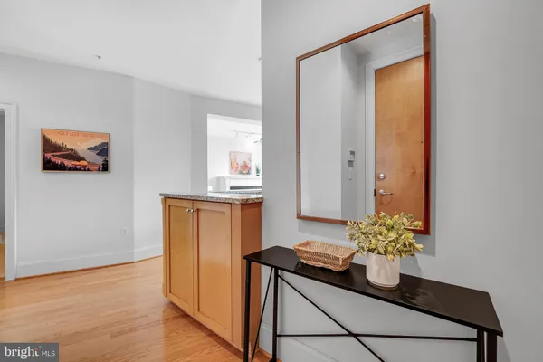 a room with a counter space and wooden floor