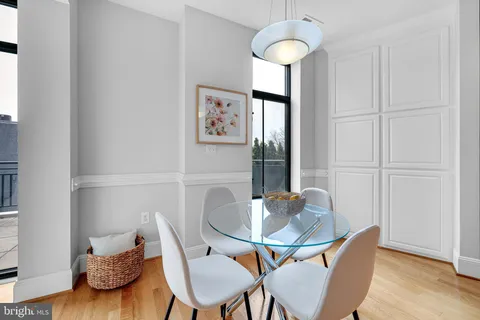 a view of a dining room with furniture wooden floor and chandelier
